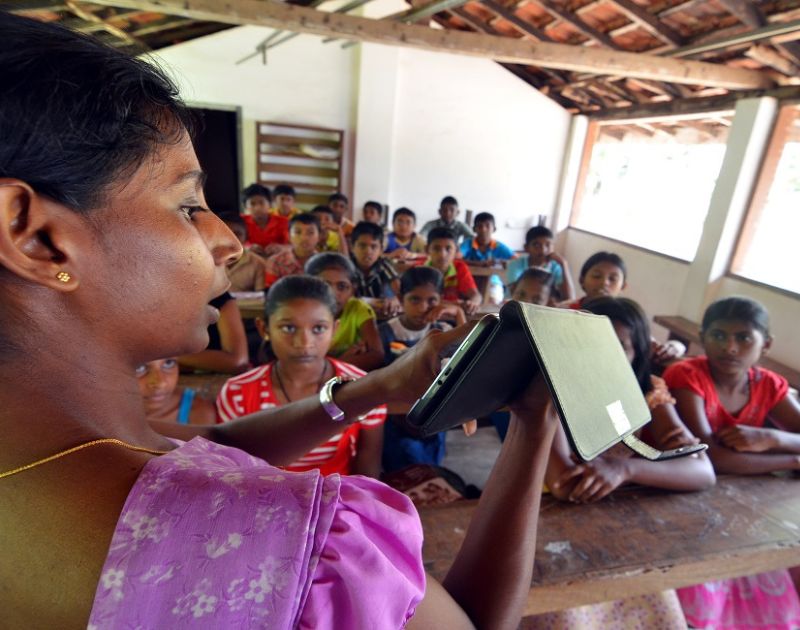 teacher with tablet computer in a classroom